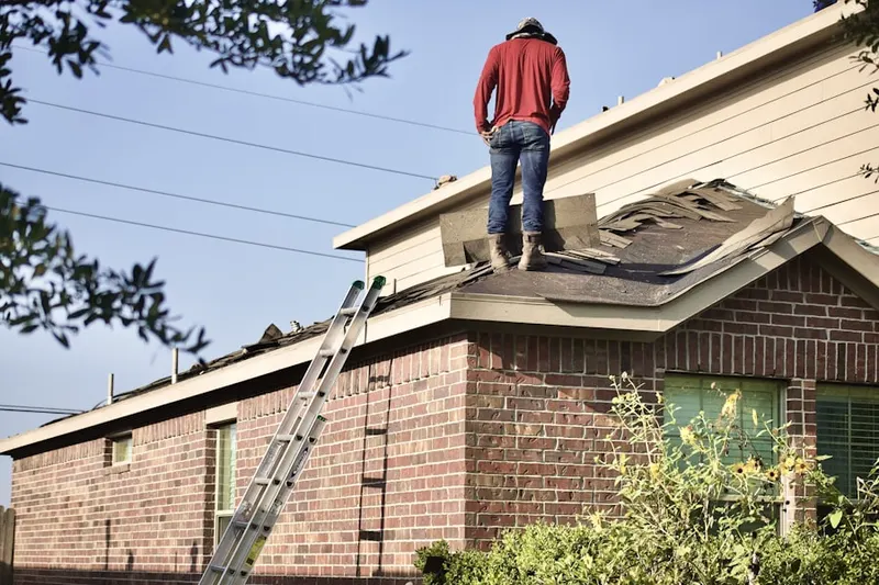 Professional roofer working on a residential roof in Kingstowne